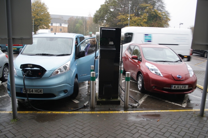 A LEAF awaits its charge as the e-NV200 fills up